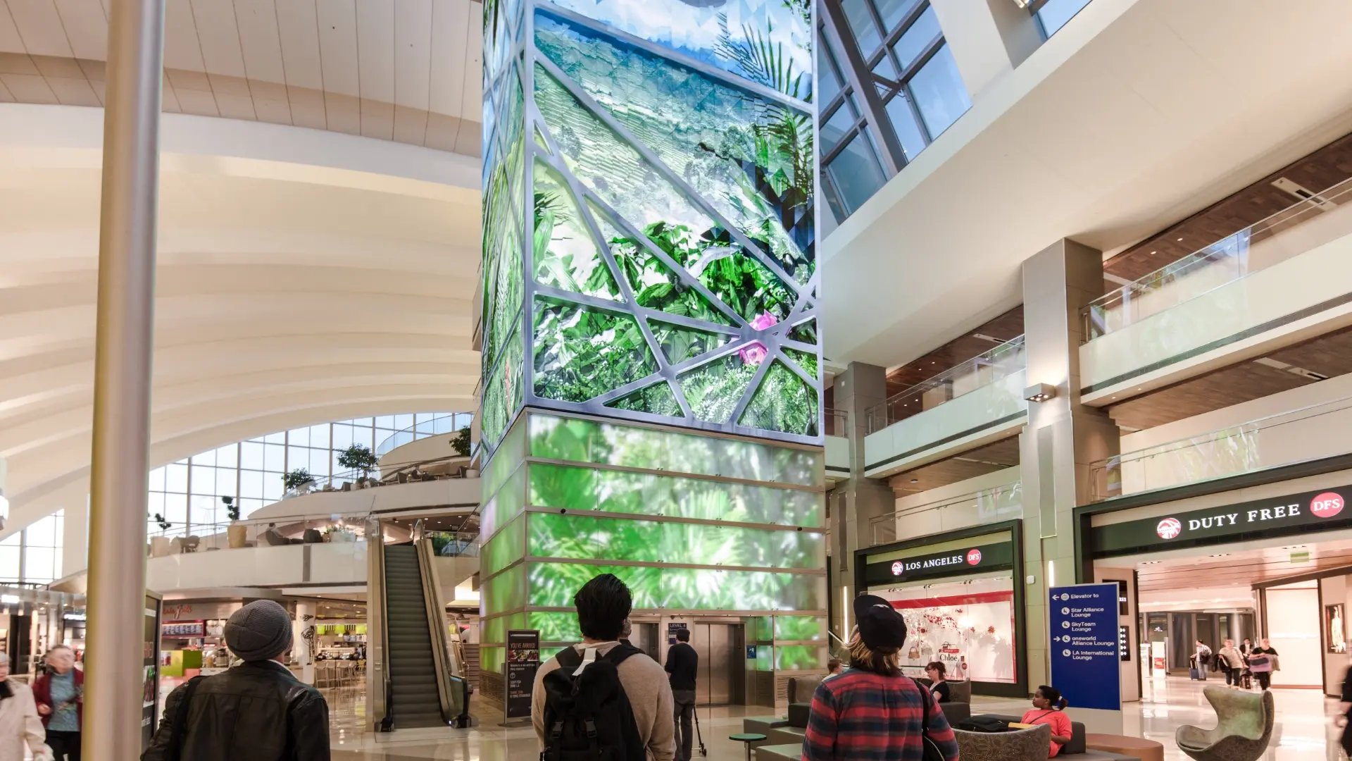 Guests admiring a large LED tower fabricated and installed by Electrosonic technicians.