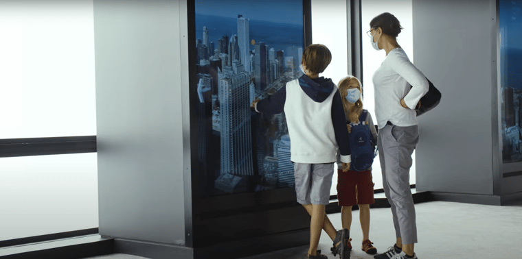 Guests interacting with an LED touchscreen at Chicago Skydeck. 