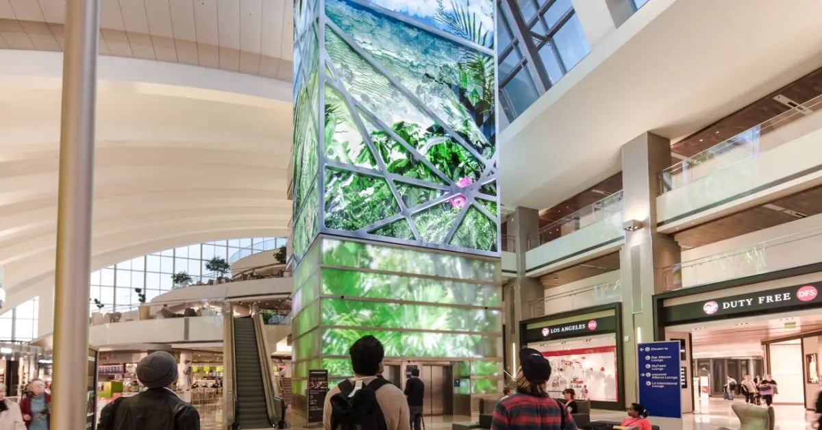 Guests looking up at an Electrosonic build video wall.