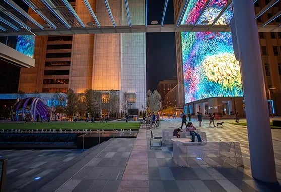 Guests relaxing and soaking in the experience at AT&T Discovery District at night.