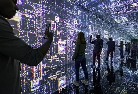 Guests taking photos of the projection experience in the infinity room at the International Spy Museum.