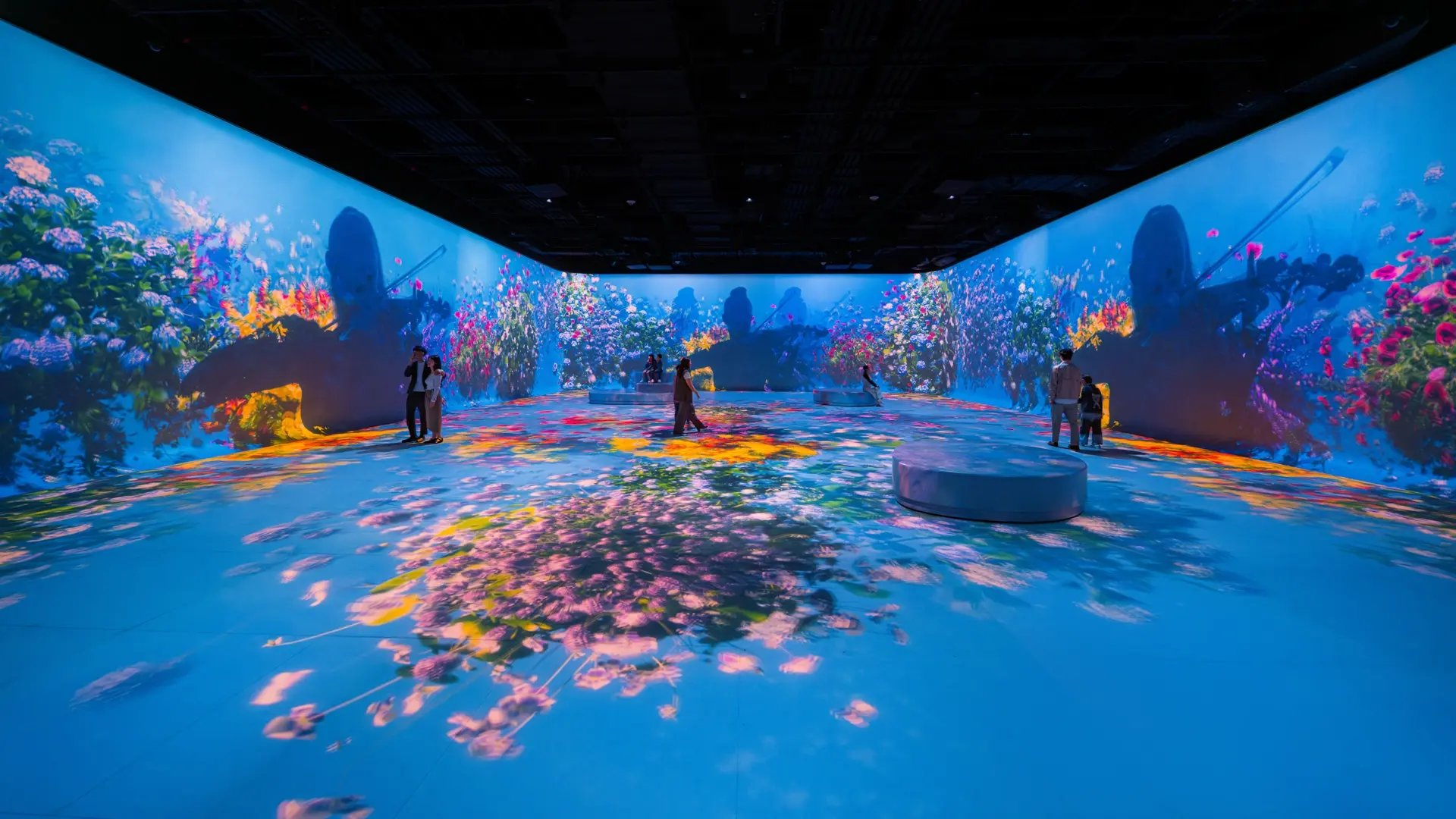Guests to Illuminarium Macau exploring the immersive projection experience brought to them by Electrosonic.