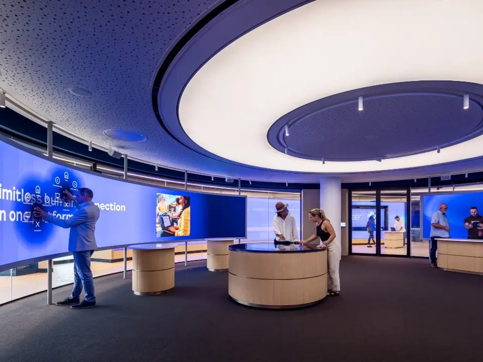 Guests to a visitor center interacting with LED touch walls and touch tables.