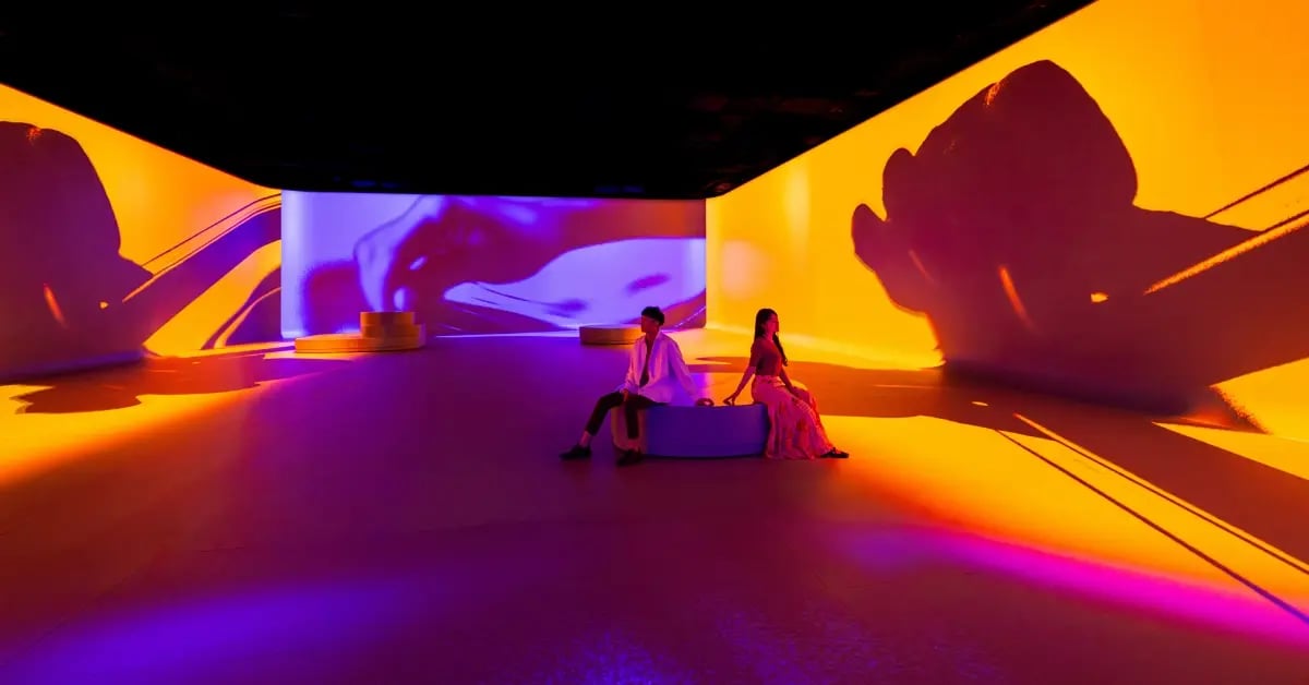 Guests to an Electrosonic designed experience viewing the projection mapped story.