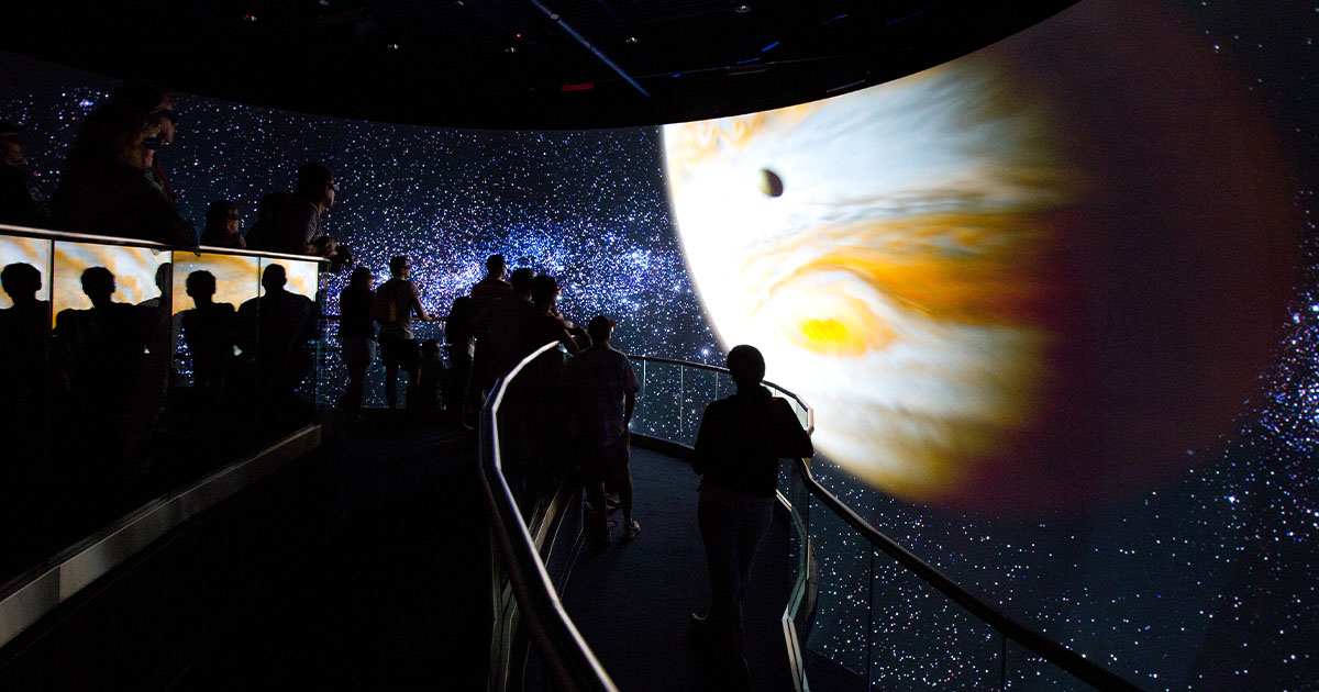 Visitors to the at Kennedy Space Center viewing a show.