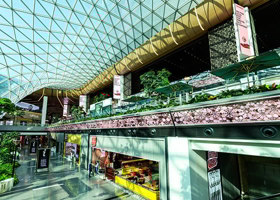 The glass atrium and LED video wall at Hamad International Airport in Doha.