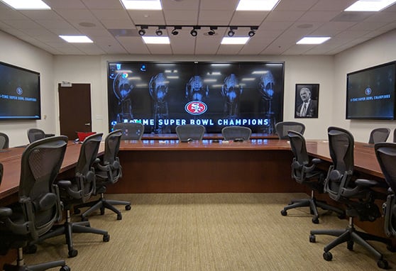 High-tech NFL draft room for the San Francisco 49ers, featuring large-format displays, advanced AV integration and a sleek, collaborative design.