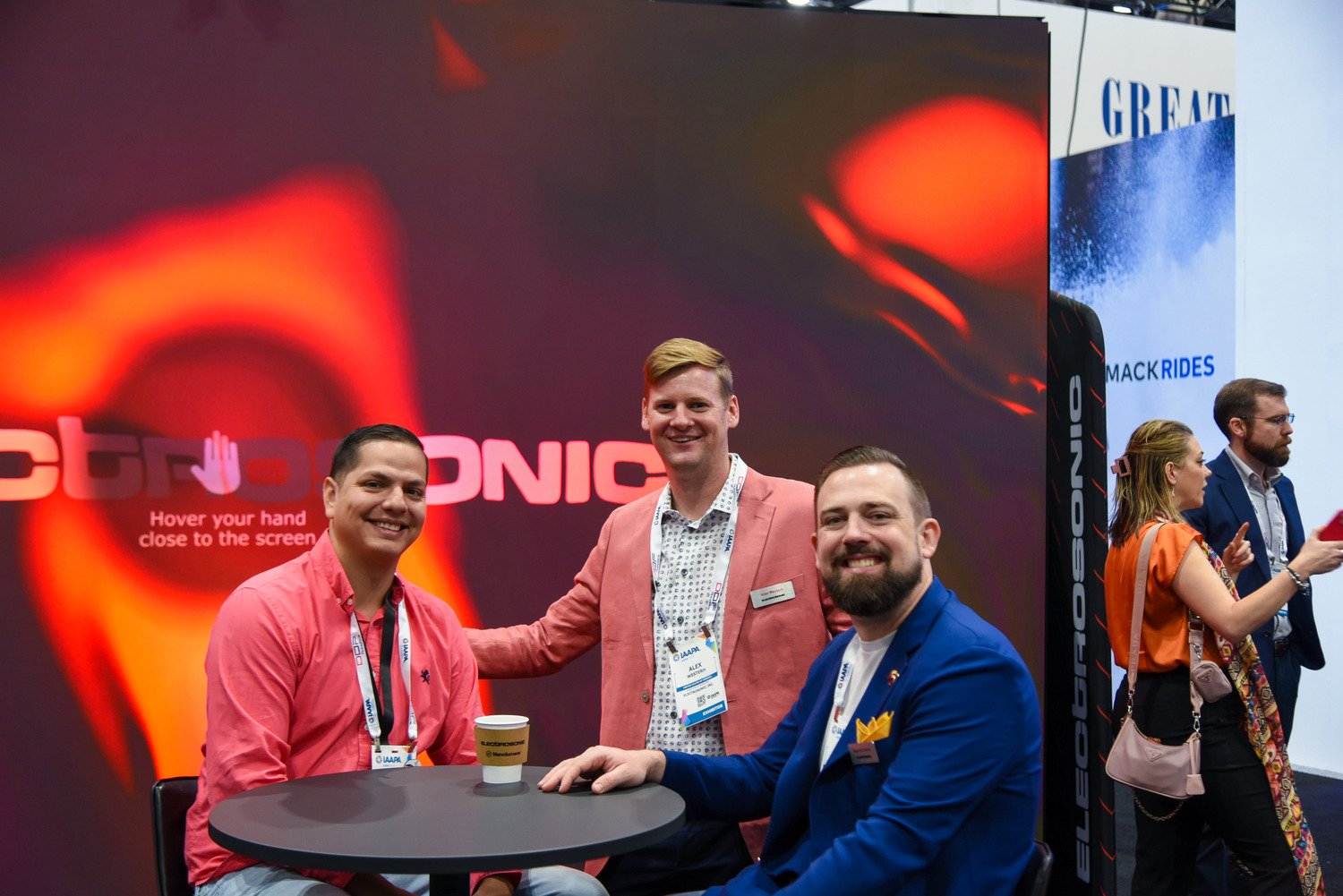 Group of young Electrosonic employees during a trade show. 
