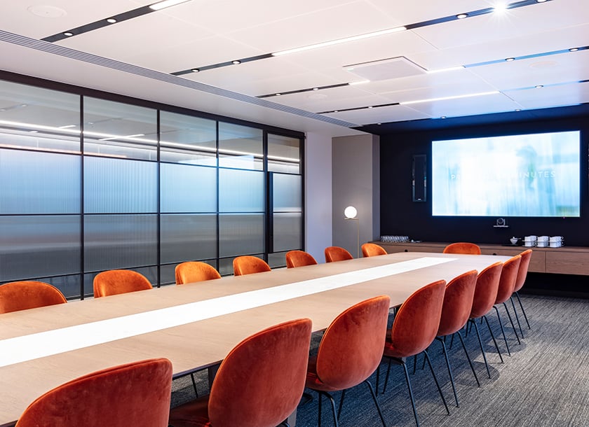 Ashurst's HQ features a sleek, modern workspace enhanced by integrated audiovisual elements, including large digital displays and seamless video conferencing systems. The technology supports dynamic collaboration and communication across stylish, open-plan meeting areas.