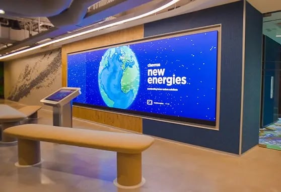 Inside Chevron’s Houston lobby, a cleanly designed LED wall displays real-time sustainability data and visual storytelling aligned with the company’s green initiatives.