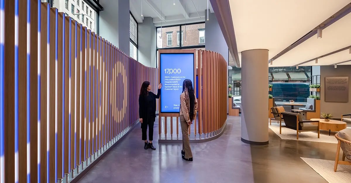 Inside the Okta Experience Center, interactive displays and video walls are used to guide clients through secure identity solutions and product demos.