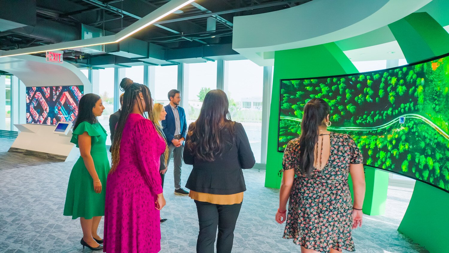 Customers being briefed in front of a series of LED installations at the Johnson Controls OpenBlue Innovation Center