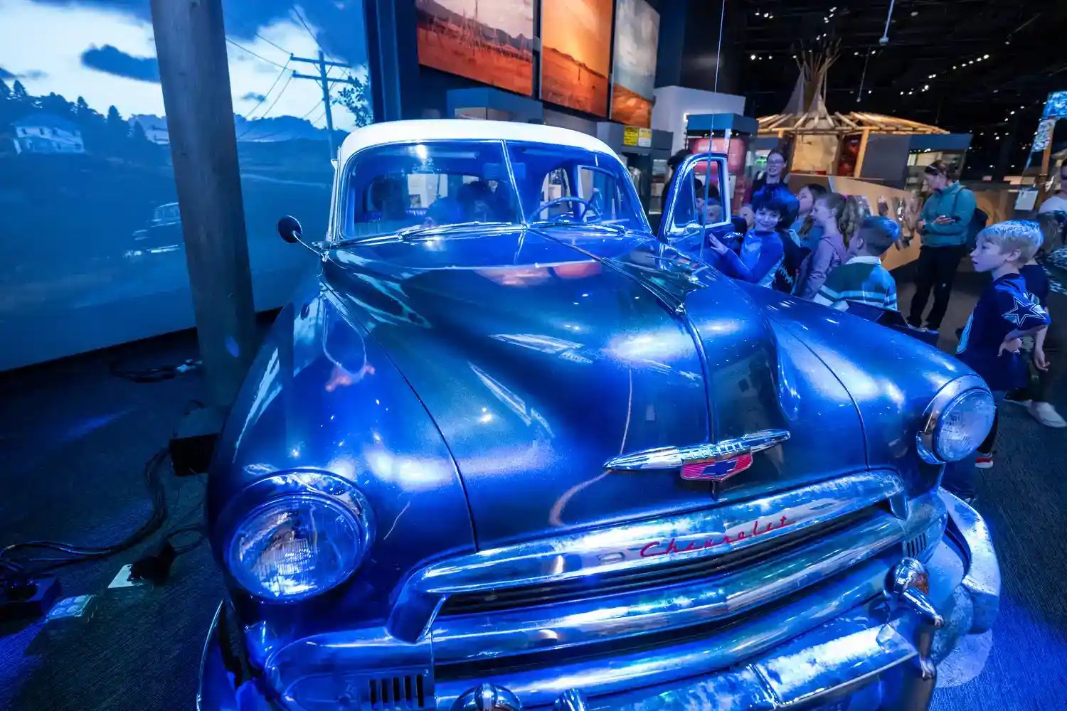 A front angle of an old fashioned car.
