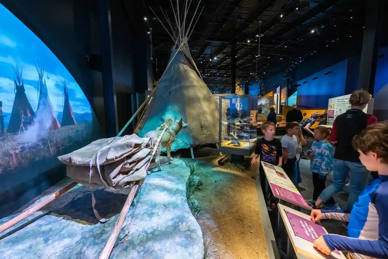 Kids interacting with tipi exhibit.