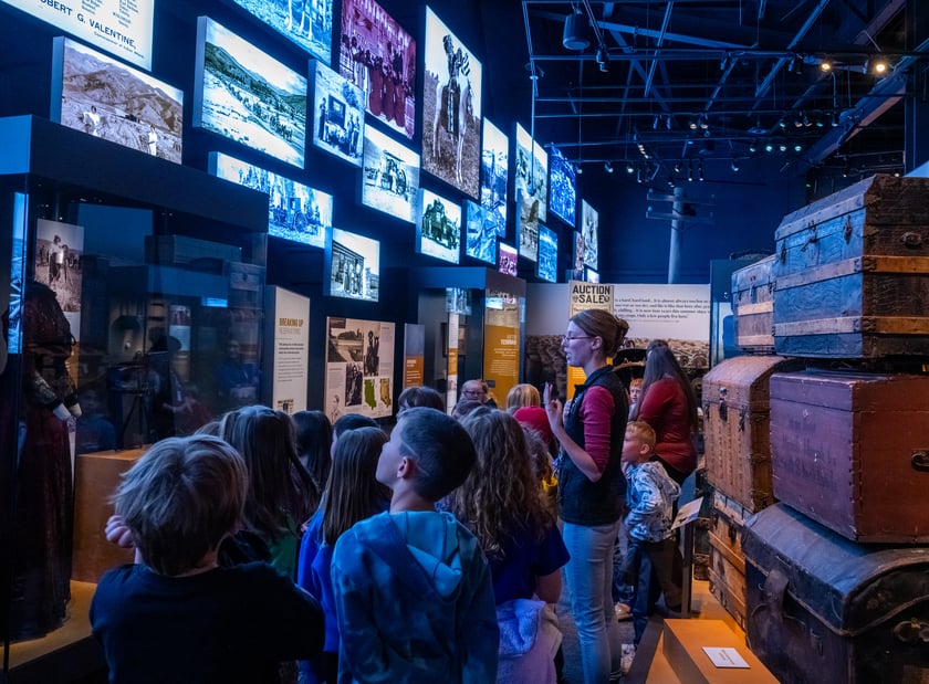 Kids looking at LED screens on the wall.