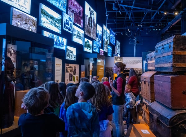 Kids looking at LED screens on the wall.