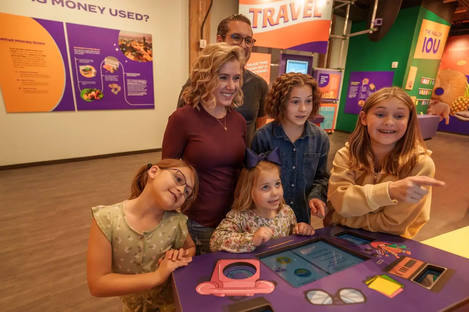 Group of people interacting with display.