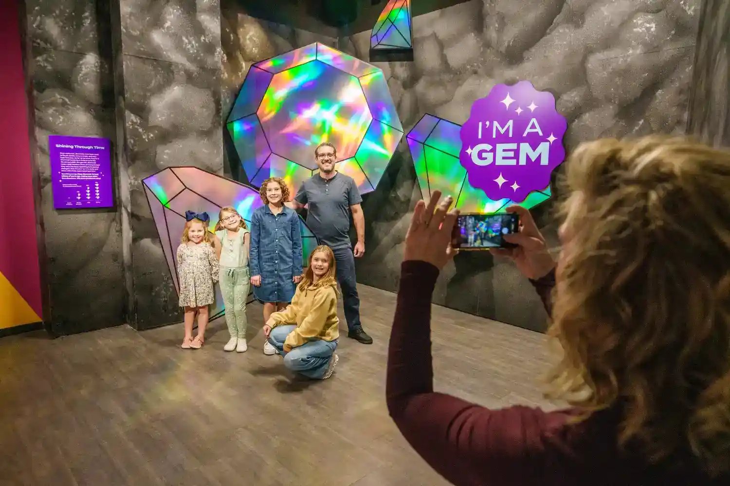 Family taking picture of diamond exhibit.