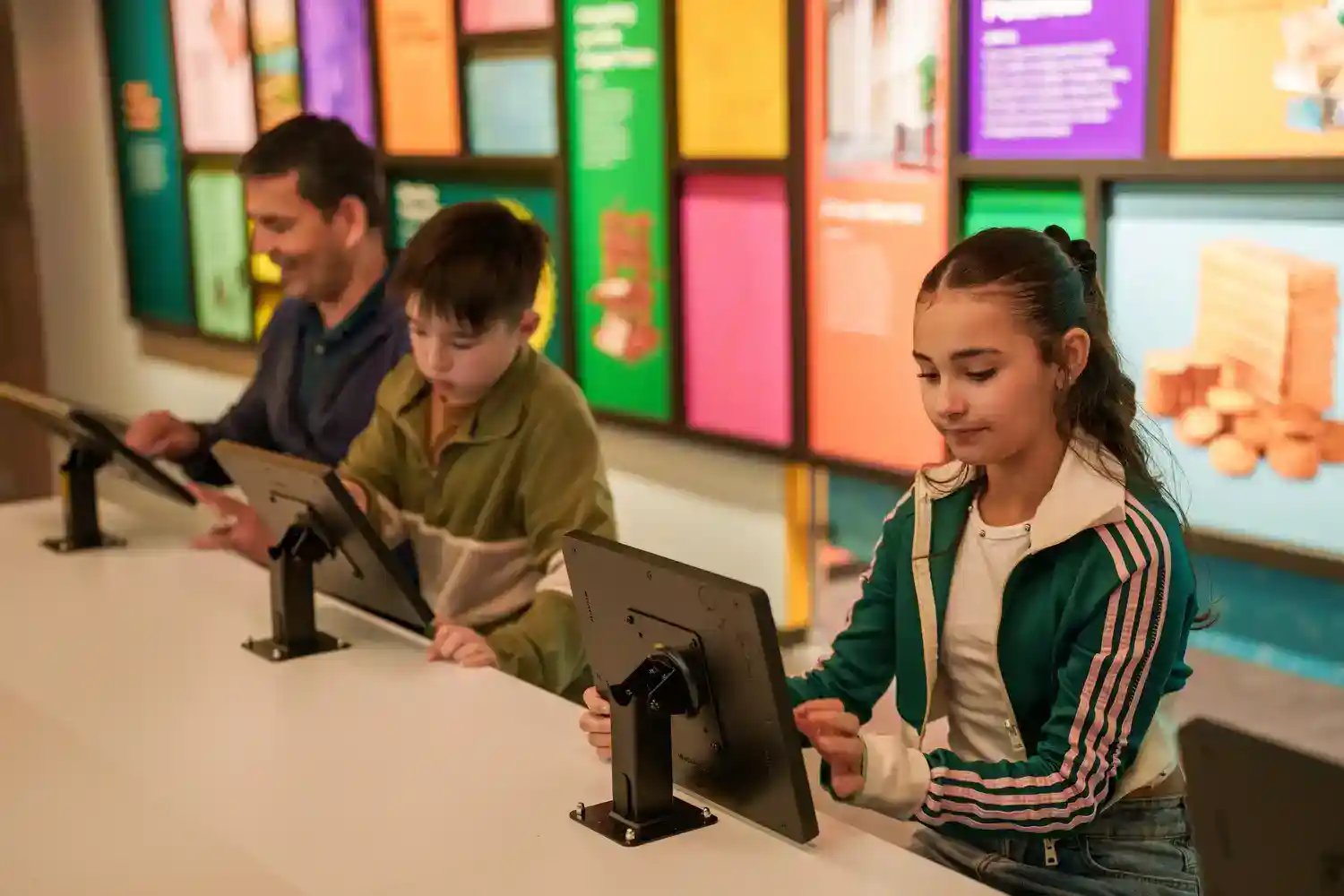 People interacting with touchscreen.