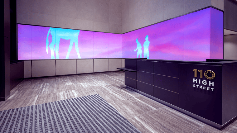 100 foot-long LED wall wrapping around the lobby and exterior facade at 110 High Street in Boston.