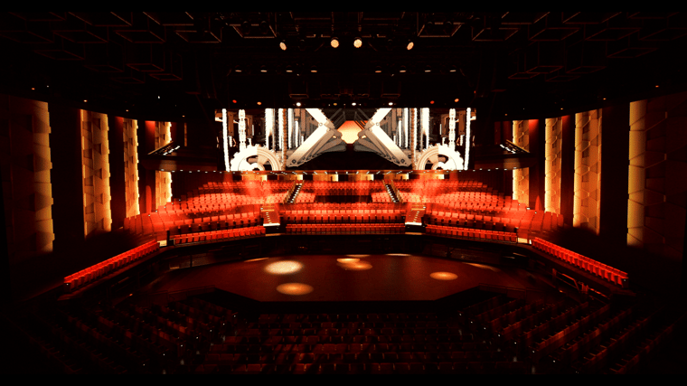 Live performance in the MGM COTAI Dynamic Theater featuring dramatic lighting, moving stage elements and a high-resolution backdrop.