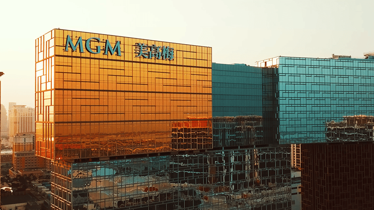 Architectural exterior of MGM COTAI with its distinctive stacked design, shimmering glass facade and surrounding cityscape.