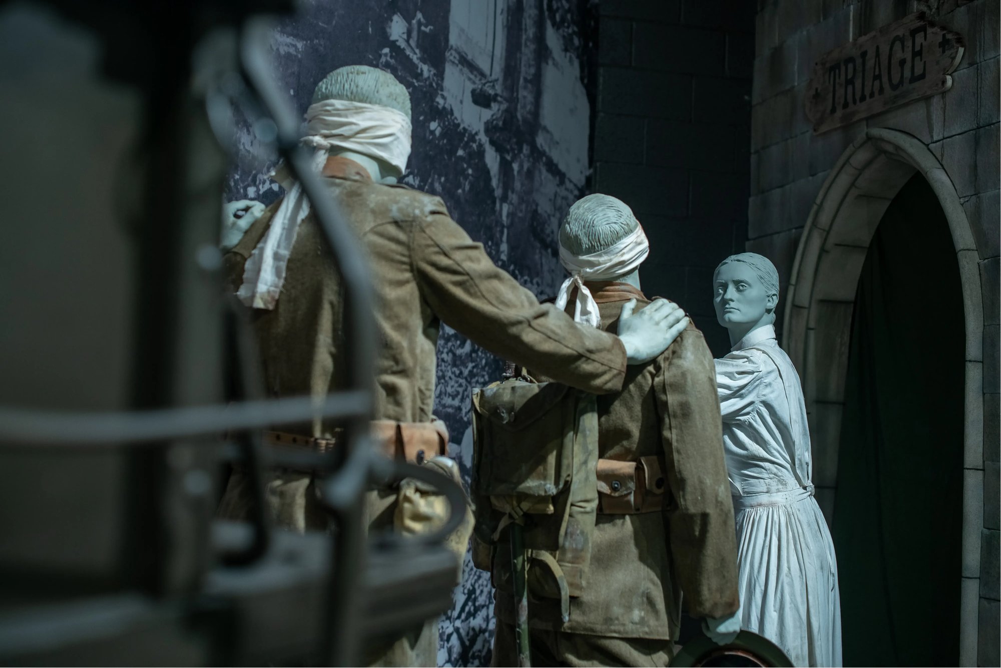 An exhibit with a medic leading two injured soldiers to safety.