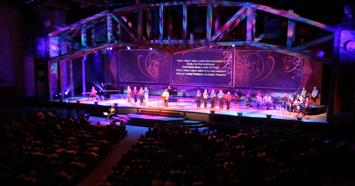 Northland Church features a spacious, modern worship area with high ceilings, soft lighting, and a large central stage. Rows of seating and advanced audiovisual elements create a welcoming and immersive environment for congregants.