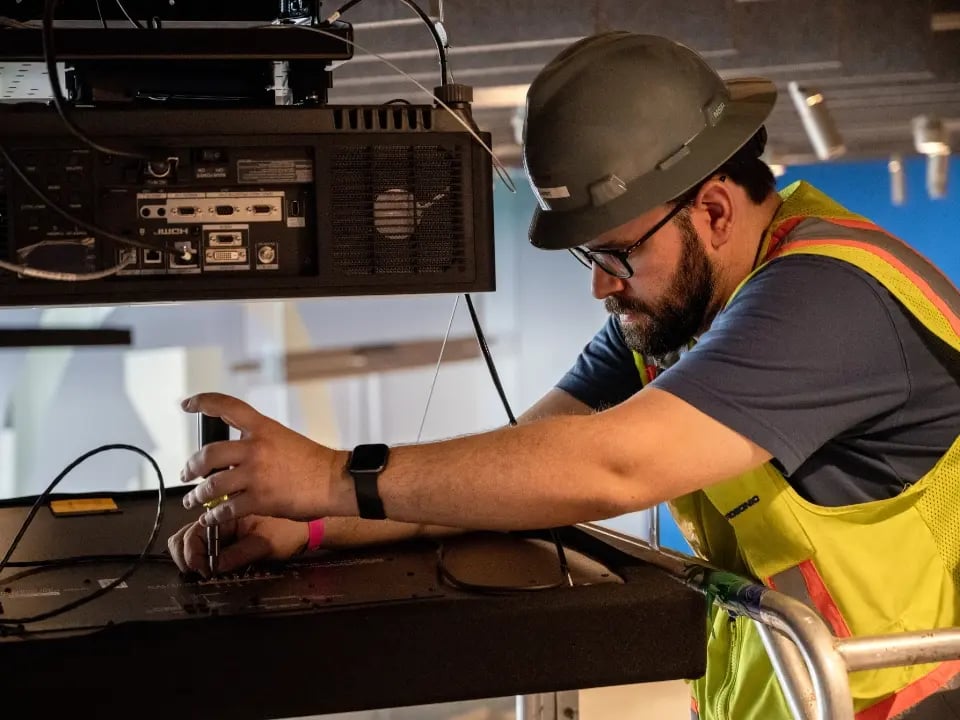 On-site Electrosonic staff work to restore seamless operation of client AV systems.