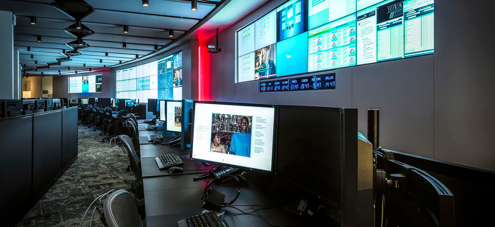 Barclays' Global Command Centre showcases a high-tech environment with expansive video walls displaying real-time data, global news, and operational metrics. The advanced audiovisual setup enables continuous monitoring and rapid response, supporting mission-critical decision-making.