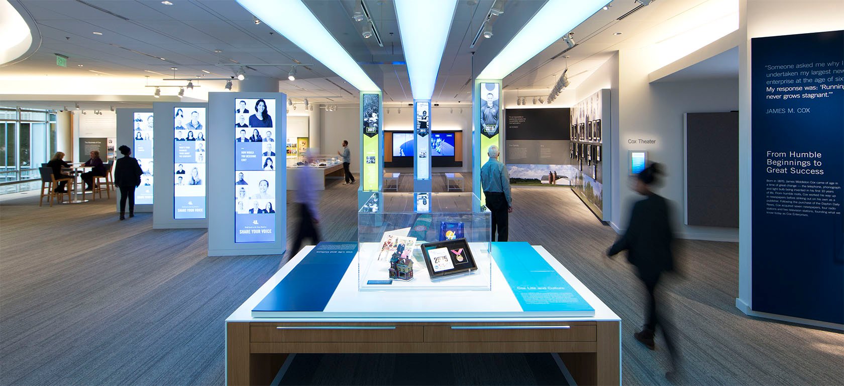 Customers and employees walking past the audiovisual installations at the Cox Discovery Center