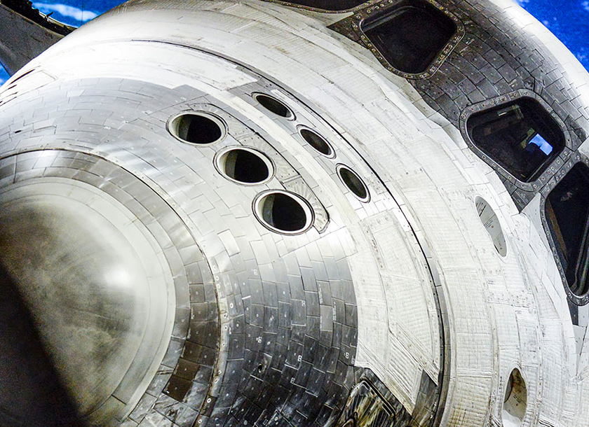 The Space Shuttle Atlantis™ visitor center features the iconic orbiter dramatically displayed with its payload bay doors open, suspended as if in flight. Surrounded by interactive exhibits and vibrant lighting, the space creates an awe-inspiring tribute to NASA’s shuttle program.