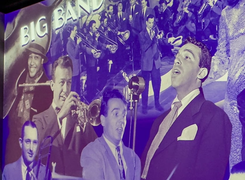 A projected wall displaying American music legends.