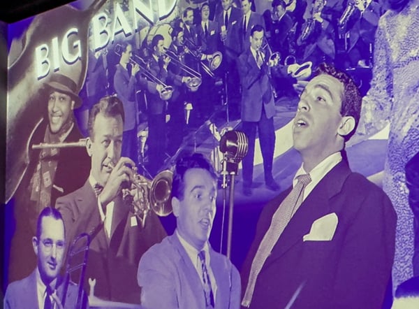 An projected wall of American music legends