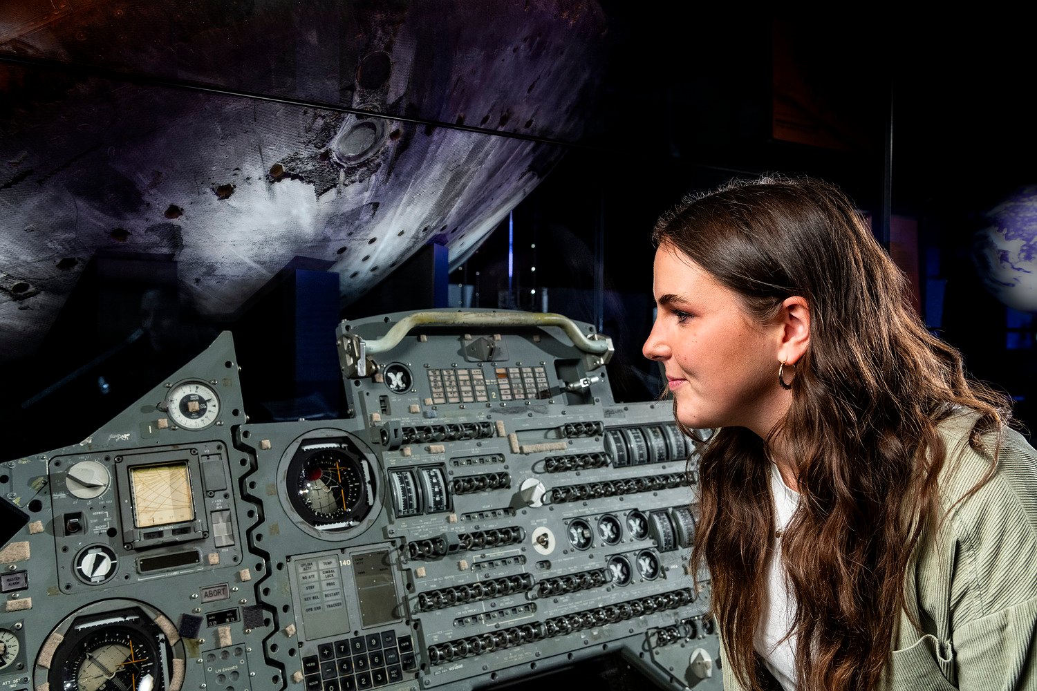 A woman looking at a control panel.