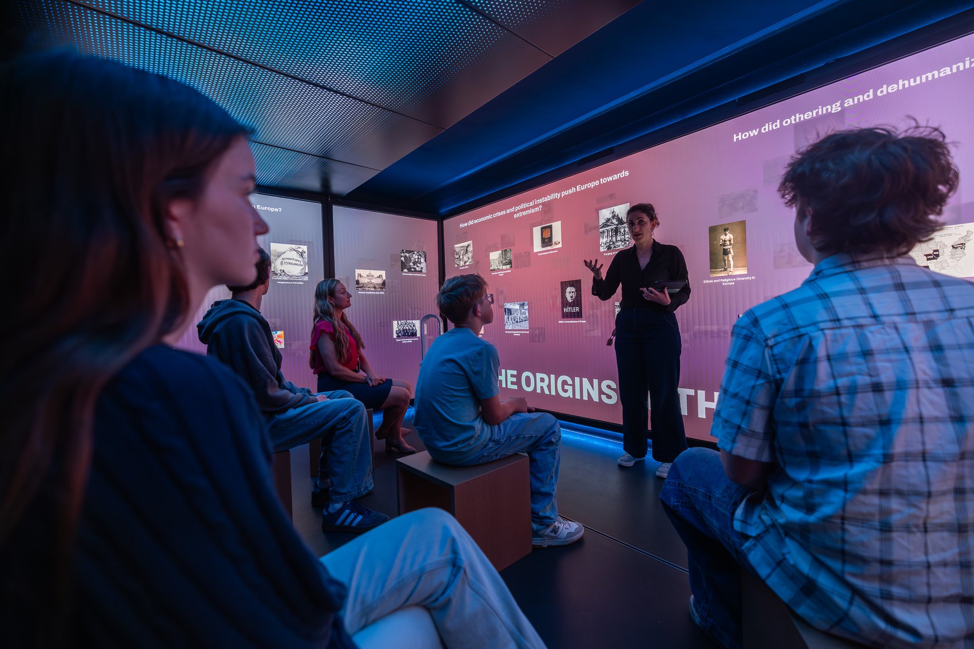 Woman talking in front of group of people.