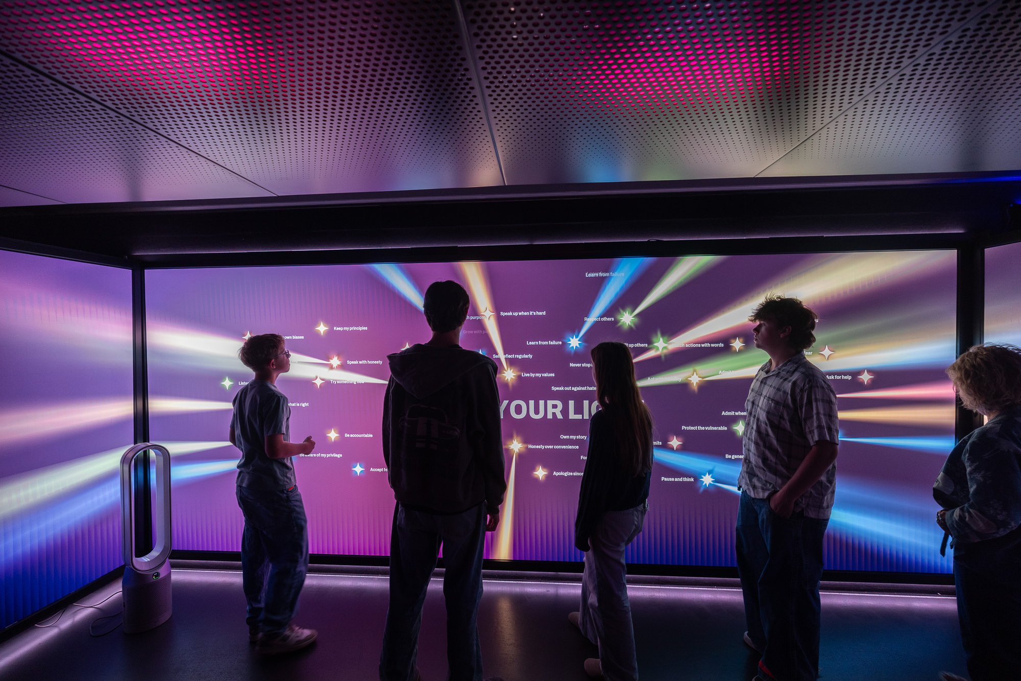 Group of people viewing LED wall.