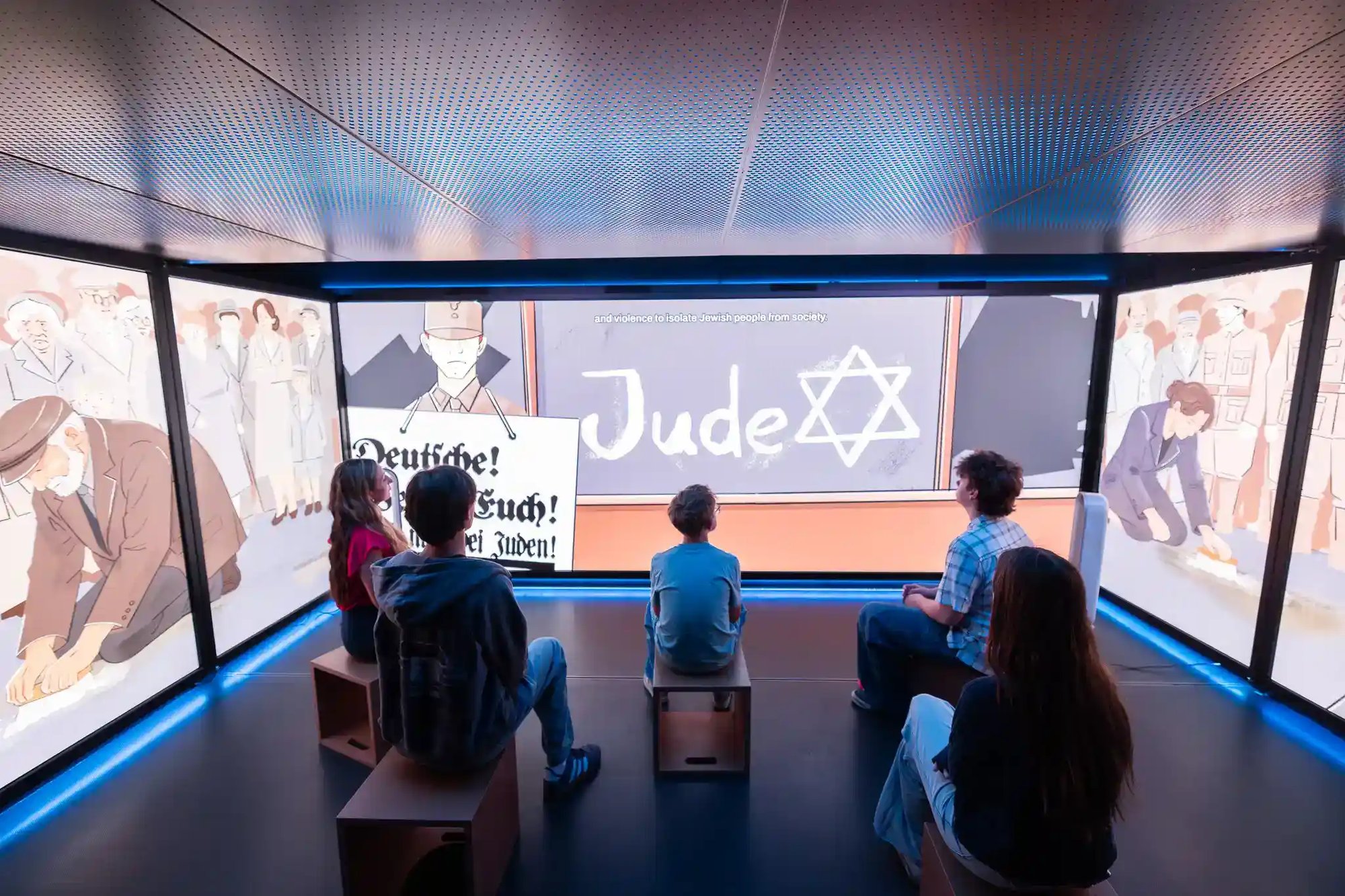 A group of people looking at media on the LED walls.