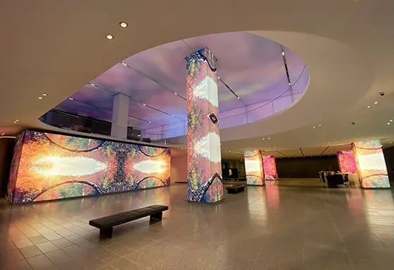 Striking LED columns and a massive video wall create a vibrant, branded welcome space.