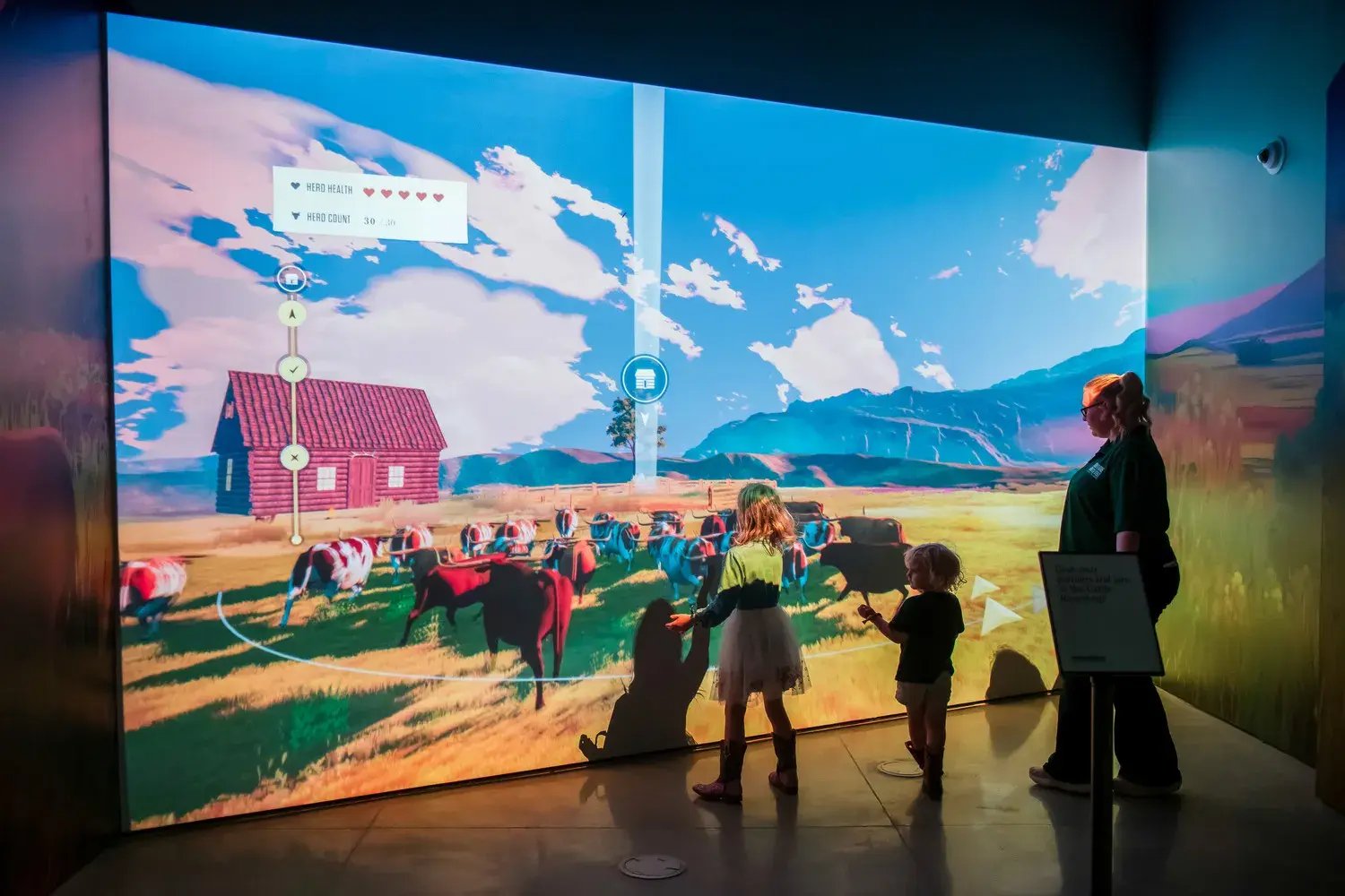 Children playing with the projection games on the wall.