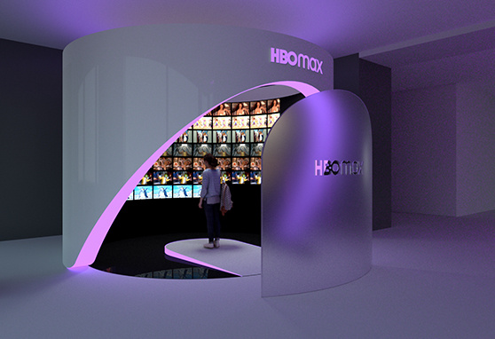 This sleek HBO Max installation features a futuristic curved structure illuminated in purple light, drawing visitors into an immersive display of vibrant screens showcasing the platform’s content
