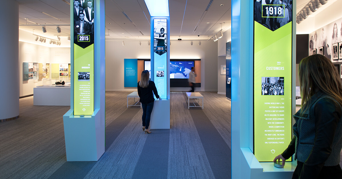 Two customers interacting with LED totems at the Cox Discovery Center