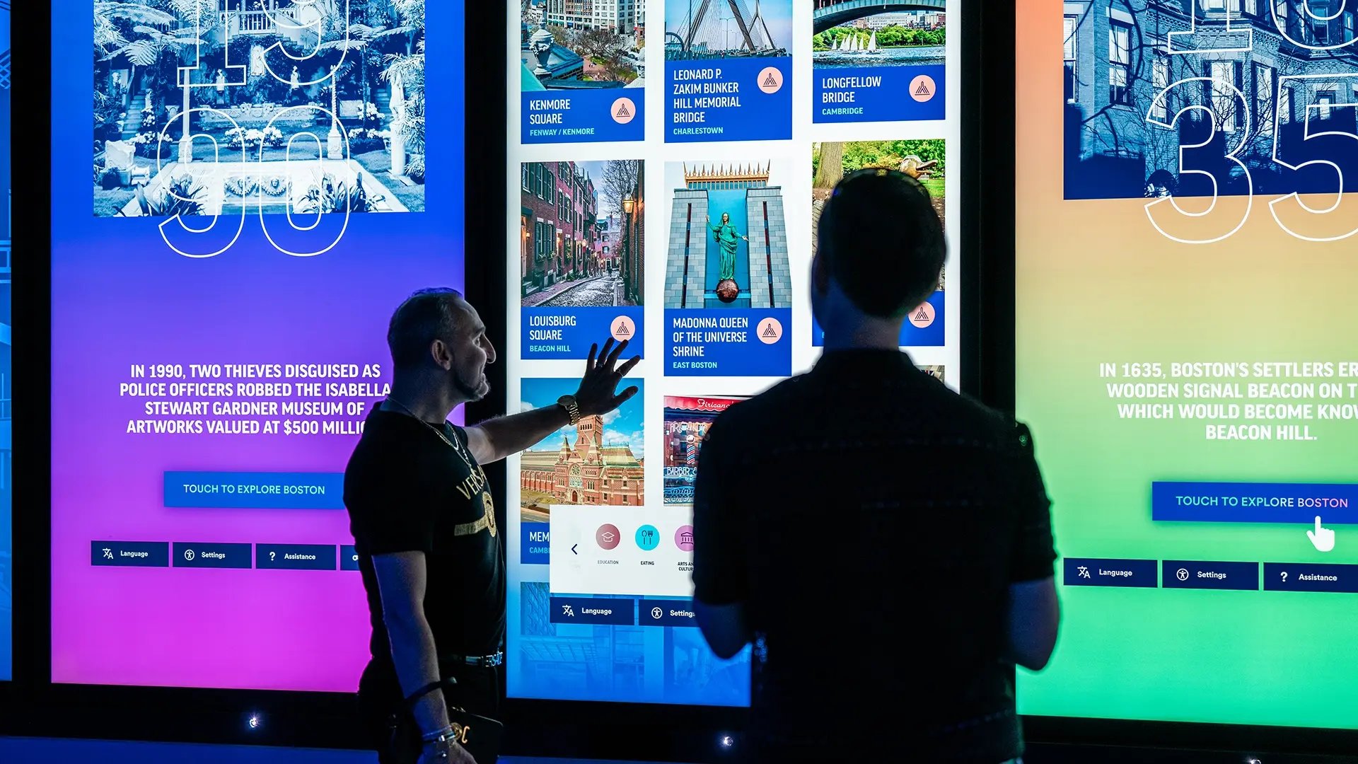 Two guests to the View Boston experience interacting with a series of highly experiential touchscreens. 