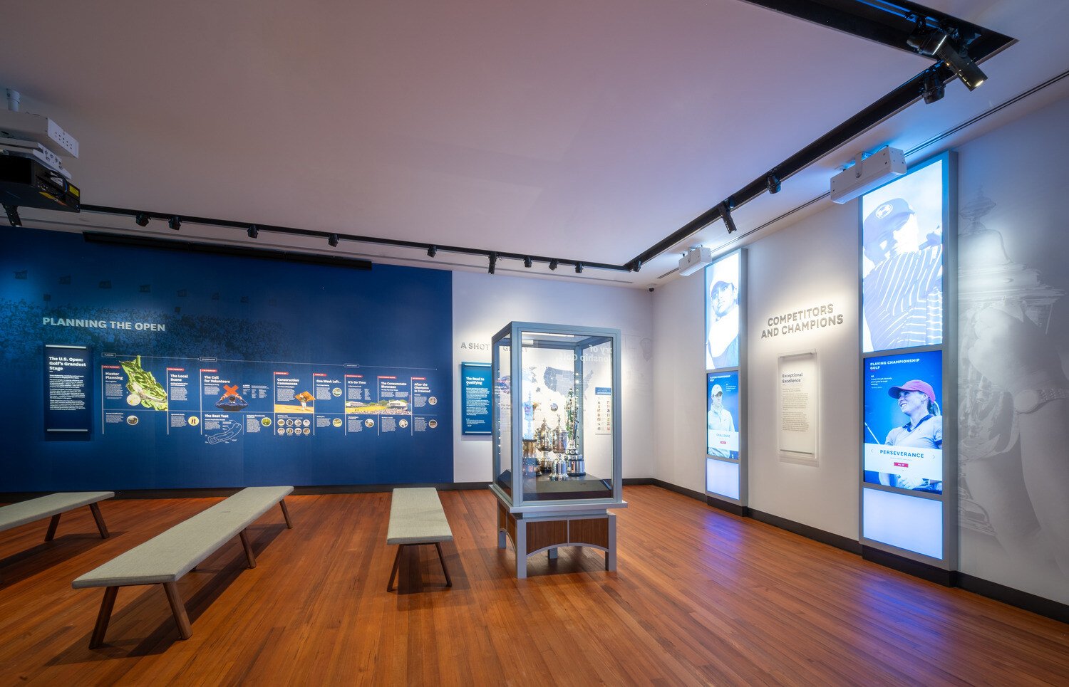Side view of a trophy case and three benches