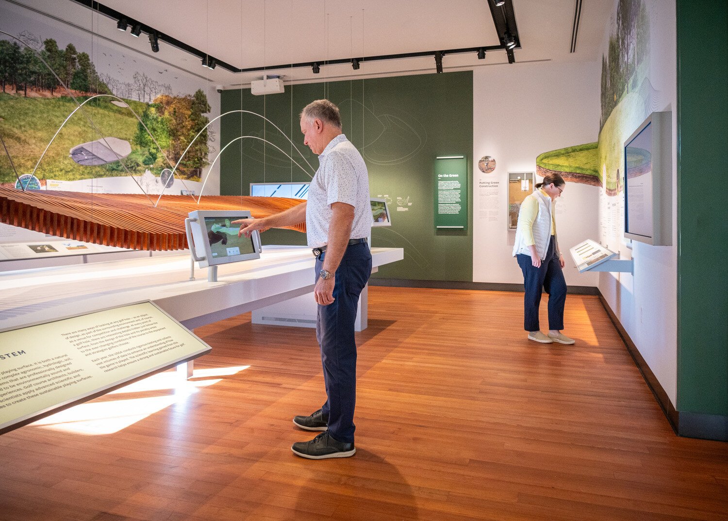 Man using table to learn the science of golf