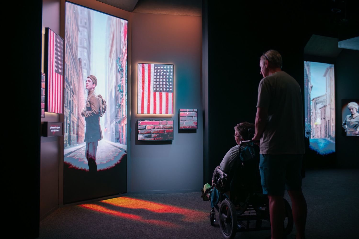 Two visitors to the National WWI Museum and Memorial viewing the encounters exhibit.