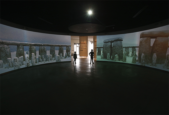 Visitors are surrounded by 360-degree screens showing views of the circle of stones.