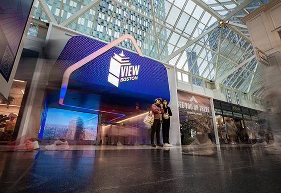 Visitors contemplating a trip to see the panoramic city views from the observation deck at View Boston.