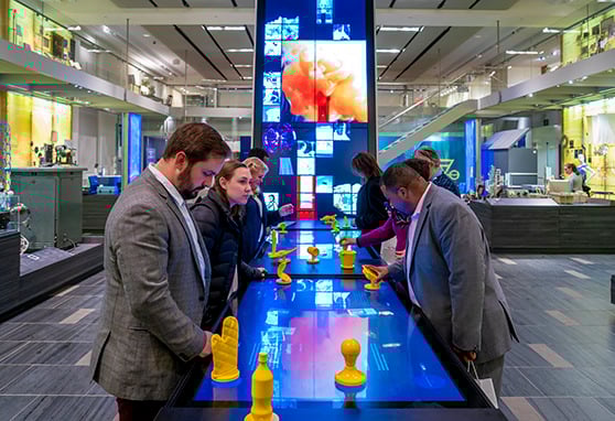 Visitors move 3-dimensional objects on an interactive table to reveal graphics and historical information about the object.