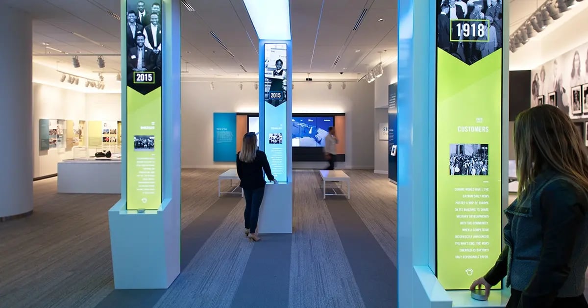 Visitors to the Cox Discovery Center interacting with LED pillars which tell stories about the companys corporate identity